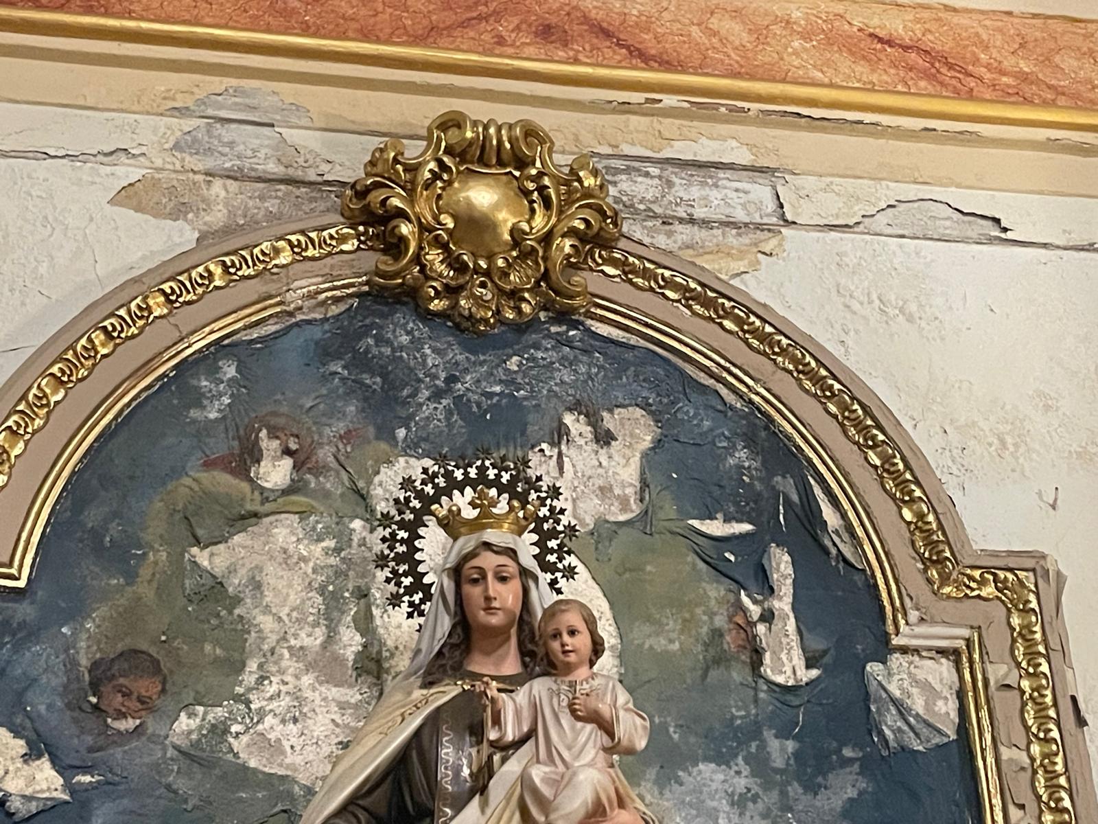 Virgen de los Ángeles con fresco deteriorado a su espalda